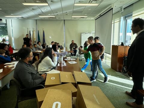A student receives a prize box from a judge